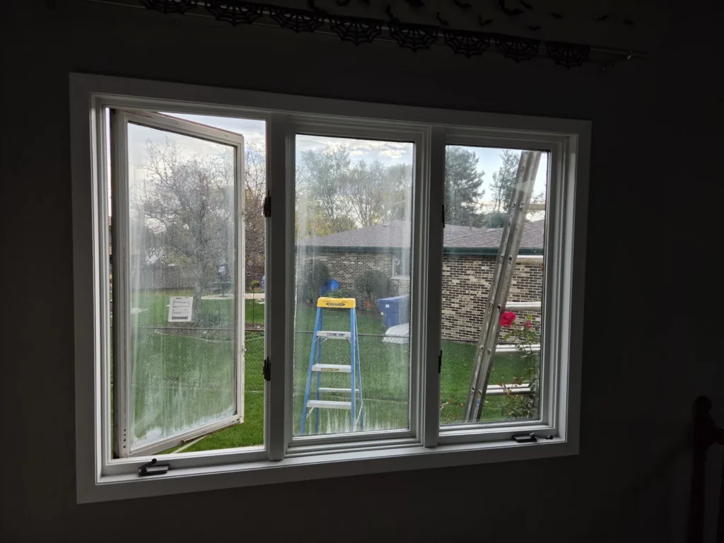 Three-part white-framed window arrangement viewed from inside a Homer Glen home