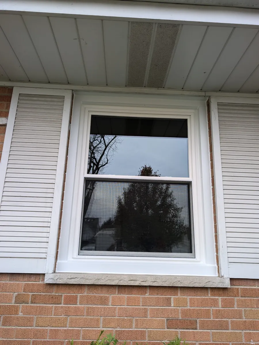 White-framed window beneath the porch roof in Franklin Park