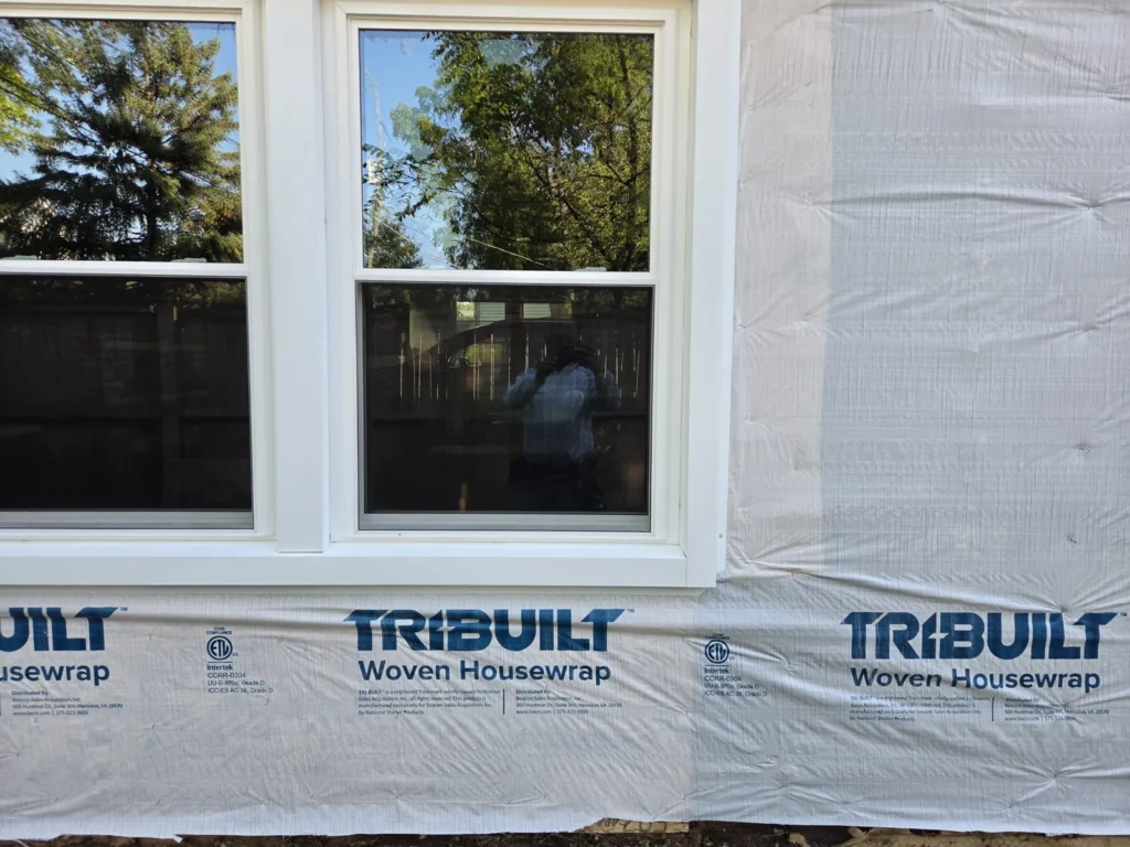 White-framed windows with housewrap at the Campbell Street project in Des Plaines