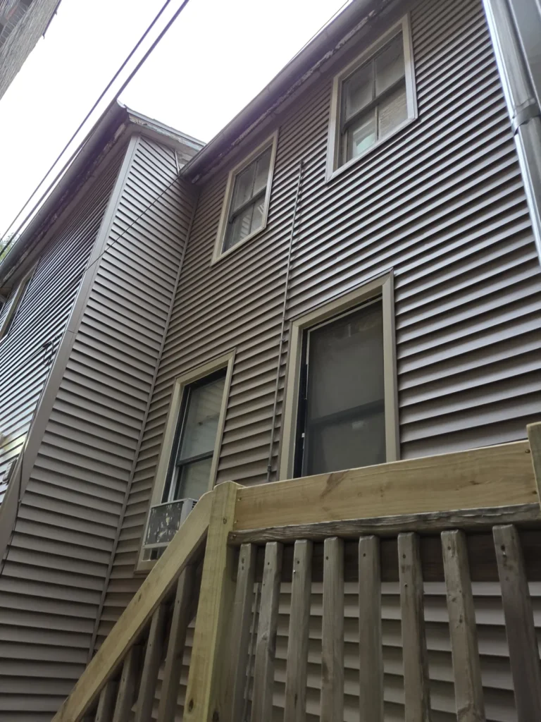 New horizontal siding around rear windows at the Huron Street home in Chicago