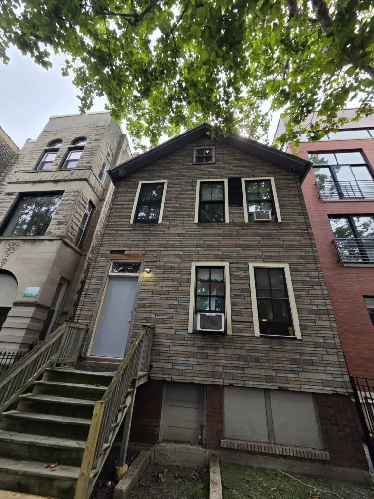 Front exterior before siding replacement on Huron Street in Chicago