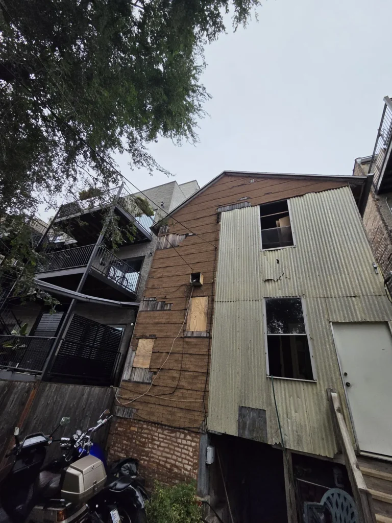 Rear wall during siding preparation at the Huron Street home in Chicago