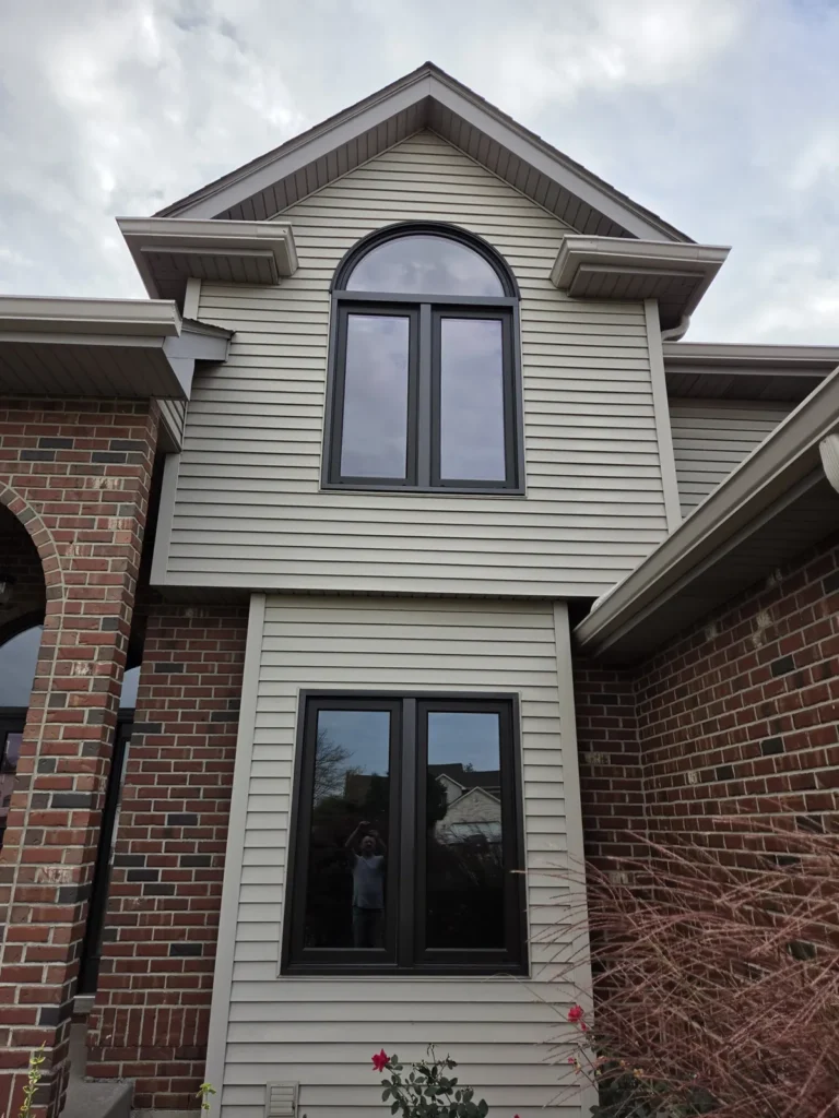 Arched and rectangular dark-framed windows at a Main Street home in Homer Glen